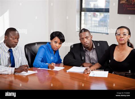 Four Black Business People Having A Boardroom Meeting