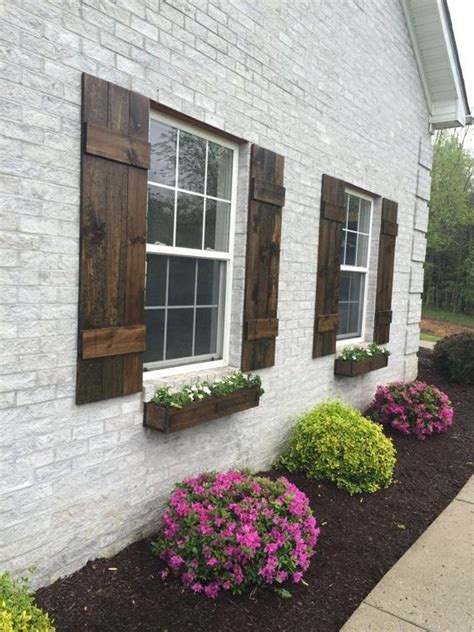 white painted brick house with wood shutters - Agustin Beatty