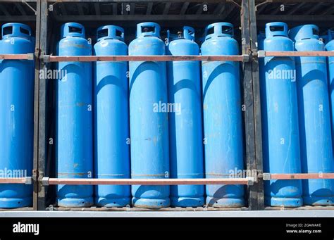 Loads of propane gas blue cylinders assorted on a truck. Tazardous ...