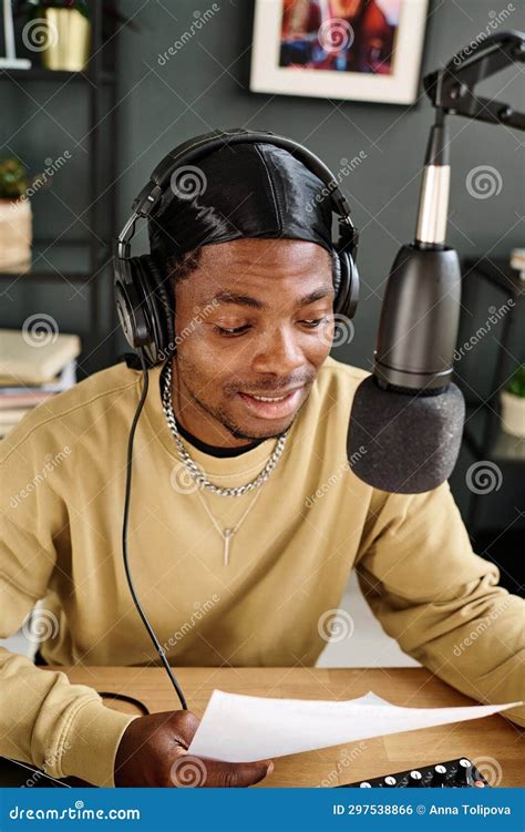 Young African American Man Looking at Paper with Text and Talking in Microphone Stock Photo ...