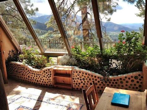 The interior of an earthship, with a built-in planter on the south side ...