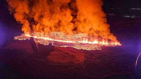 A volcano erupts in southwestern Iceland, sending lava flowing toward a ...