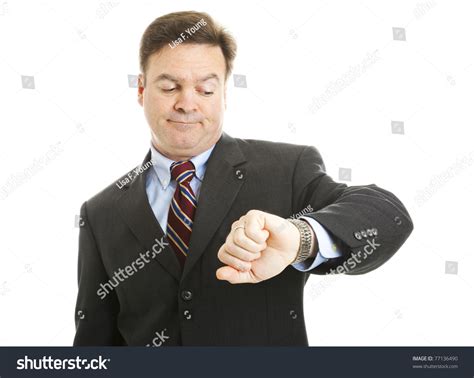 Impatient Businessman Checks His Watch. Isolated On White. Stock Photo 77136490 : Shutterstock