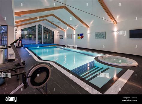 Pool house with swimming pool and gym Stock Photo - Alamy