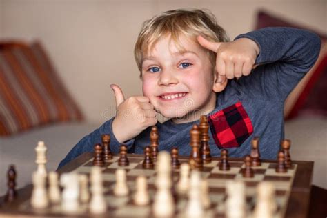 Small Child 5 Years Old Playing a Game of Chess on Large Chess Board ...