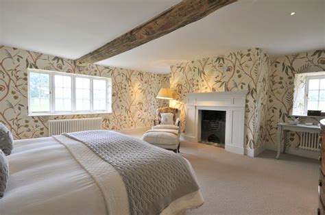 William Morris style pattern wallpaper is perfect for this traditional period bedroom, complet ...