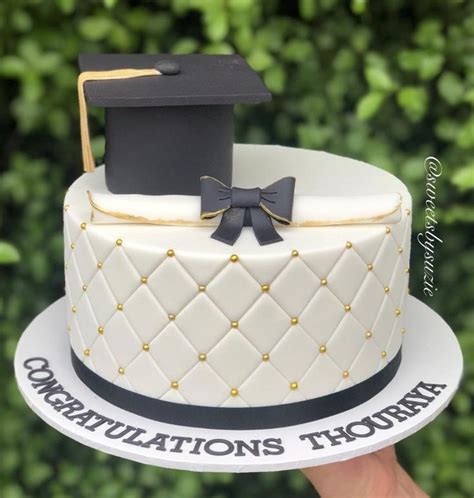 a cake with a graduation hat on top and congratulationss thomas written ...