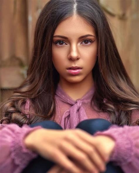 a woman with long hair and pink shirt