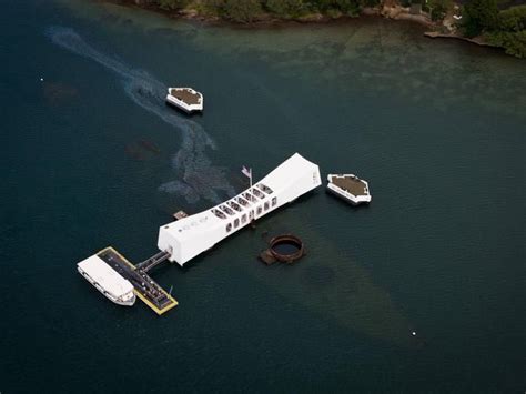 An aerial view of the USS Arizona Memorial over the sunken USS Arizona ...