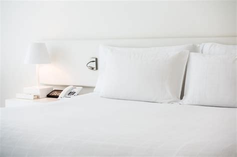 White bed with white pillows Photo | Free Download