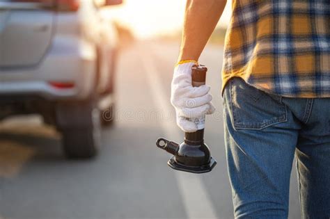 Broken Car on the Road. Man Holding Car Lifting Jack To Repair His Car Stock Image - Image of ...