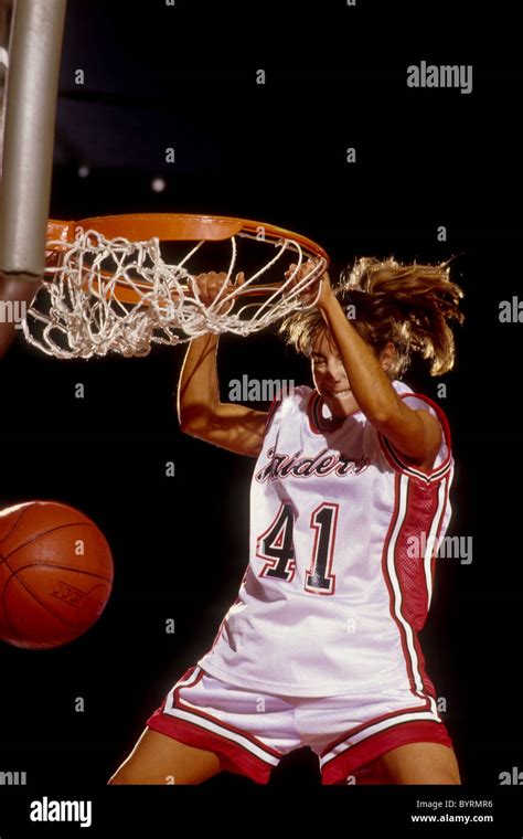 Female basketball player slam dunking Stock Photo - Alamy