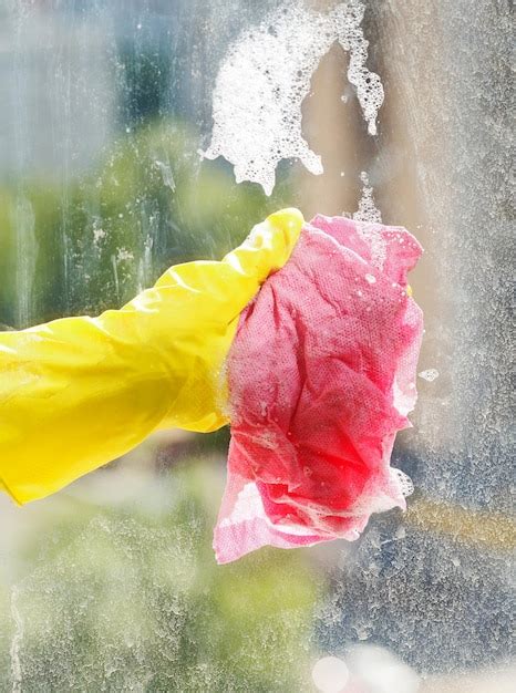 Premium Photo | Washing window glass by foamy water