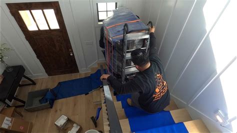 Moving a heavy piano upstairs with tight landings by Rescue Movers in ...