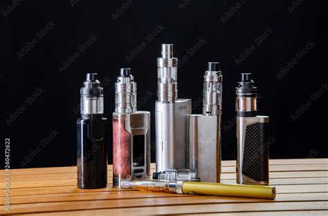 Popular vaping e cig devices mod.electronic cigarette over a black ...