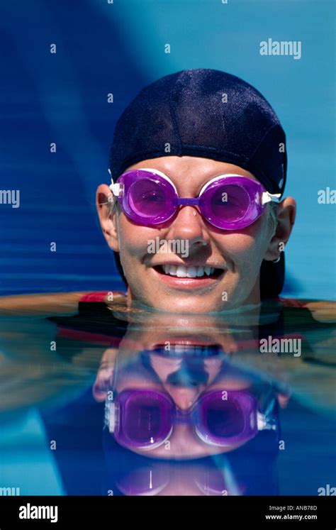 VA Chesapeake Riverwalk Pool Female swimmer in cap goggles at water surface Stock Photo - Alamy