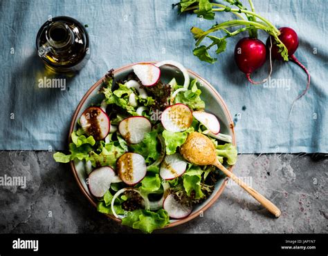 Closeup of salad bowl with dressing Stock Photo - Alamy