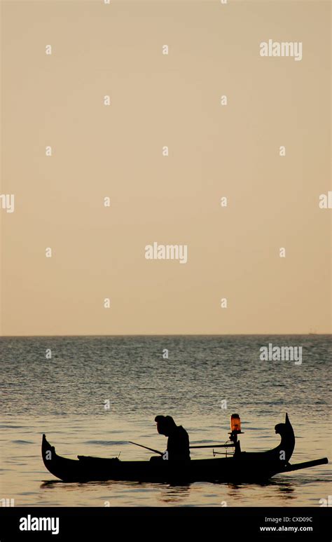 fishing boat in sunset Stock Photo - Alamy