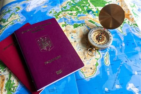 Premium Photo | Passports and map for travel old compass on map