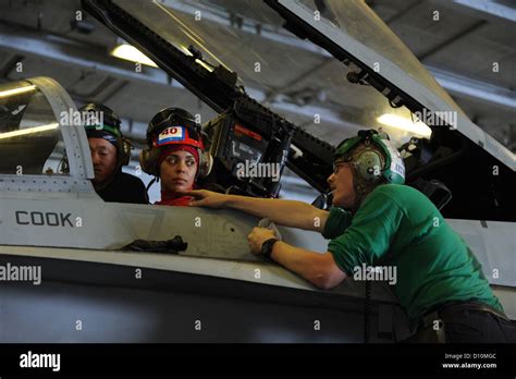 USS Dwight D. Eisenhower crew perform maintenance in the hangar bay aboard the Nimitz-class ...