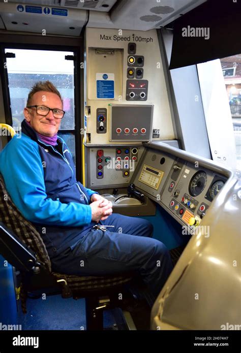 Train driver inside cab of a Chiltern Railways train by arriva at Birmingham Moor Street station ...