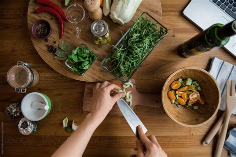 "Female Cooking Salad" by Stocksy Contributor "Milles Studio" - Stocksy