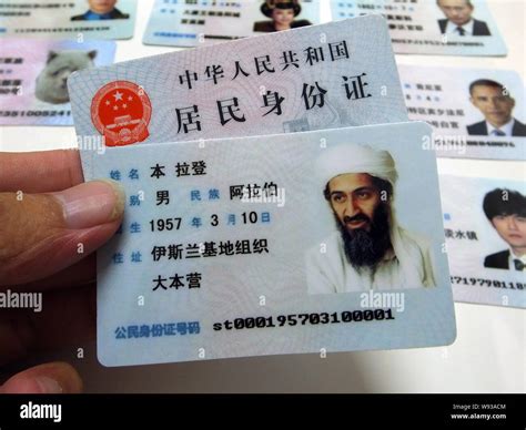 A man shows a fake Chinese ID card of former Al-Qaeda leader Osama bin ...