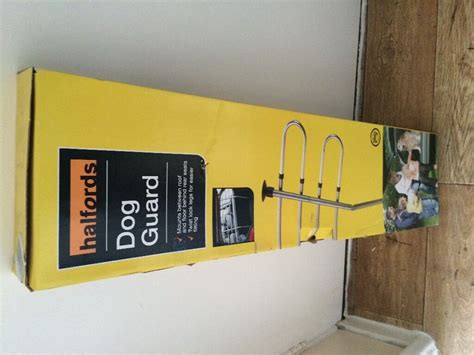 Halfords dog guard for car in box. | in Woking, Surrey | Gumtree