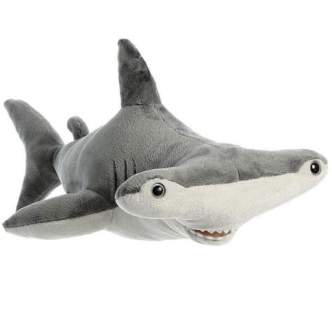 a stuffed shark with its mouth open on a white background