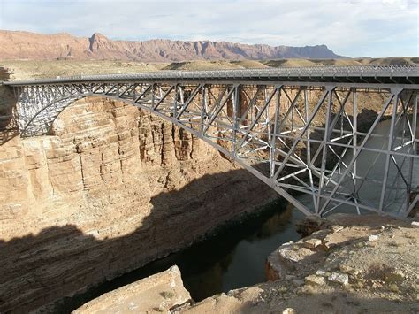 HD wallpaper: photo of gray metal bridge on brown rock formation at daytime | Wallpaper Flare