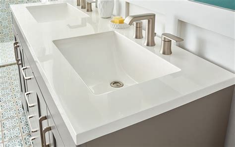 A white solid surface bathroom vanity top. - Choosing a Bathroom Vanity #bathroomvanitytops ...