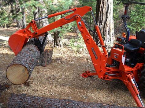 MT618 mini excavator thumb on a Kubota BH90 backhoe log lifting 1