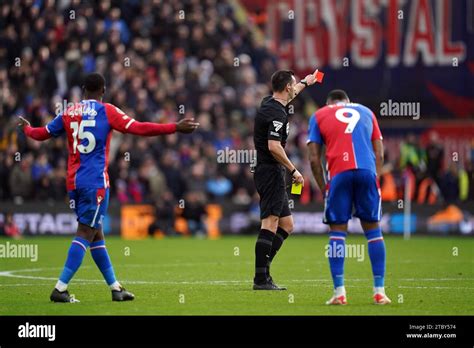 Referee Andrew Madley shows a red card to Crystal Palace's Jordan Ayew (right) during the ...