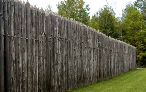 palisade: a fence of pales or stakes set firmly in the ground, as for ...