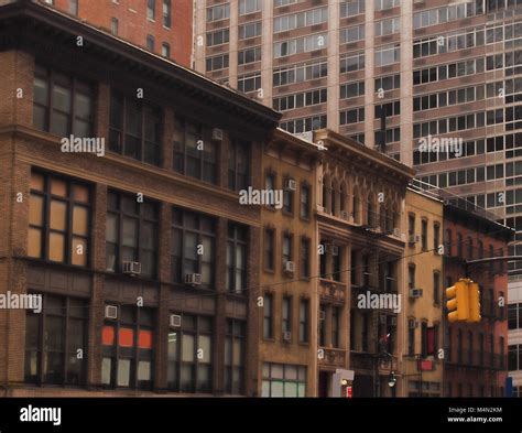 Vintage old building surrounded by modern office buildings in New York ...