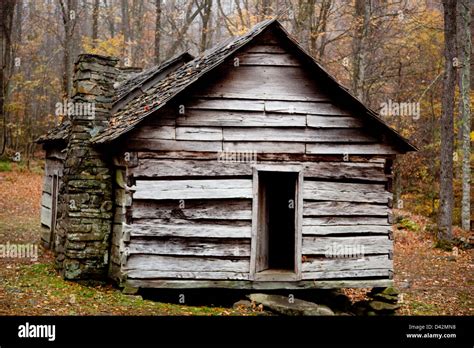 Old, rustic log cabin, with the fall woods in the background, from Great Smoky Mountain Park, in ...