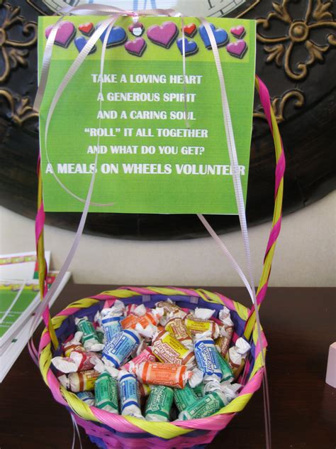 a basket filled with candy sitting on top of a table next to a sign ...