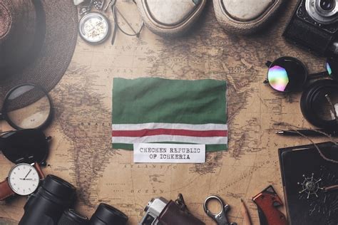 Premium Photo | Chechen republic of ichkeria flag between traveler's accessories on old vintage ...