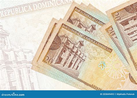 20 Dominican Peso Bills Lies in Stack on Background of Big Semi-transparent Banknote. Abstract ...