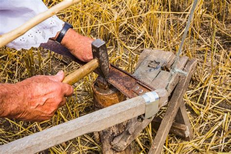 Sharpening a scythe stock photo. Image of agriculture - 35732314