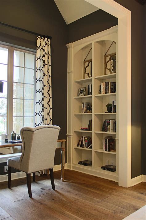 Built-in office bookshelves with arched top in bone white