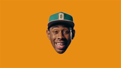 Download Tyler The Creator stands in the foreground of an orange landscape | Wallpapers.com