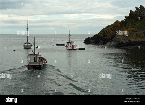 Fishing boats leaving Looe harbour, Cornwall, United Kingdom Stock ...