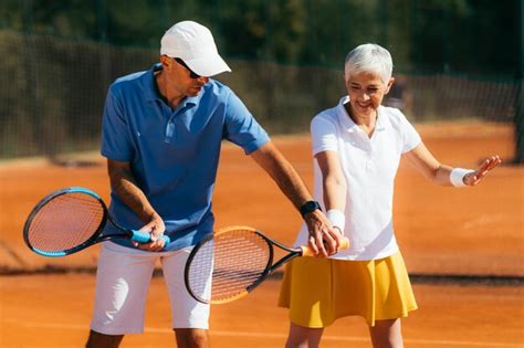 Premium Photo | Tennis instructor with senior woman tennis training lesson