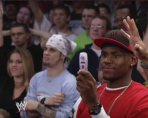 LeBron James at WWE Monday Night Raw taking a photo with a flip phone ...