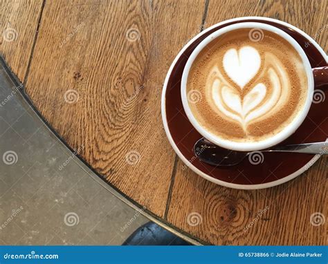 Close Up Flat White Latte Art on a Wooden Table Against a Concrete Floor from Above Stock Photo ...