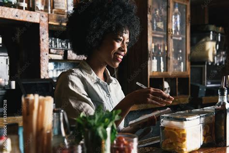 Bartender working behind bar in pub Stock Photo | Adobe Stock