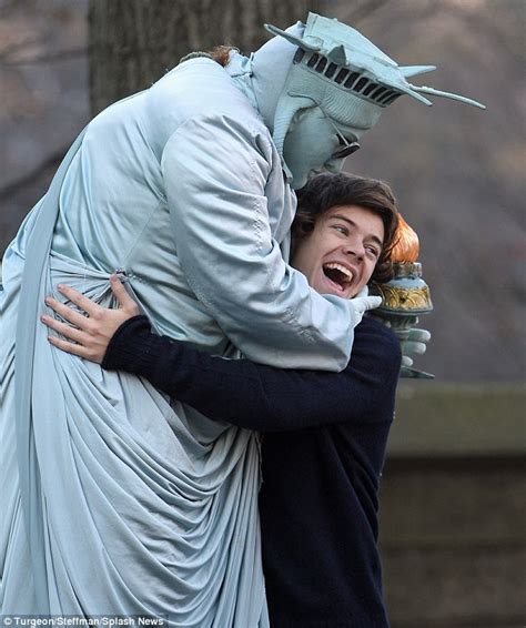 Harry Styles gets a hug from the Statue of Liberty as he and One Direction bandmates lark about ...