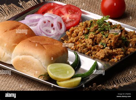 Masala Anda Bhurji or Spicy Indian scrambled eggs with bread or Bun Pav ...