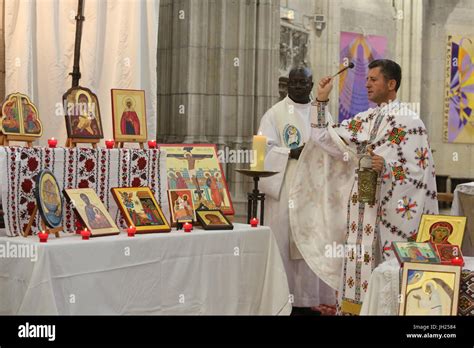 Melkite (Greek-catholic) priest blessing icons in Sainte Foy church ...